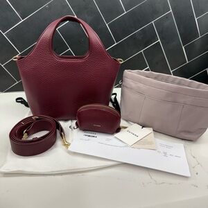 Cuyana Cherry (Burgundy) Mini System Tote Bag with adjustable crossbody strap.